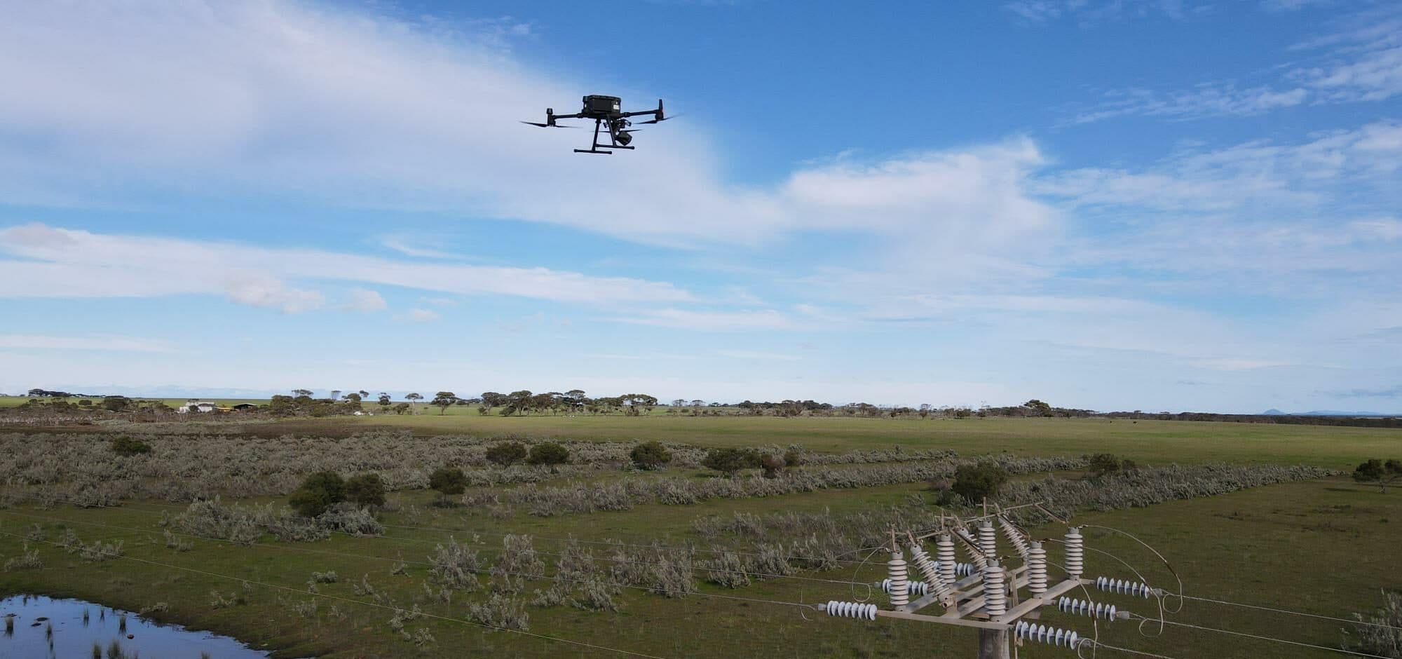 Drone inspecting power line infrastructure
