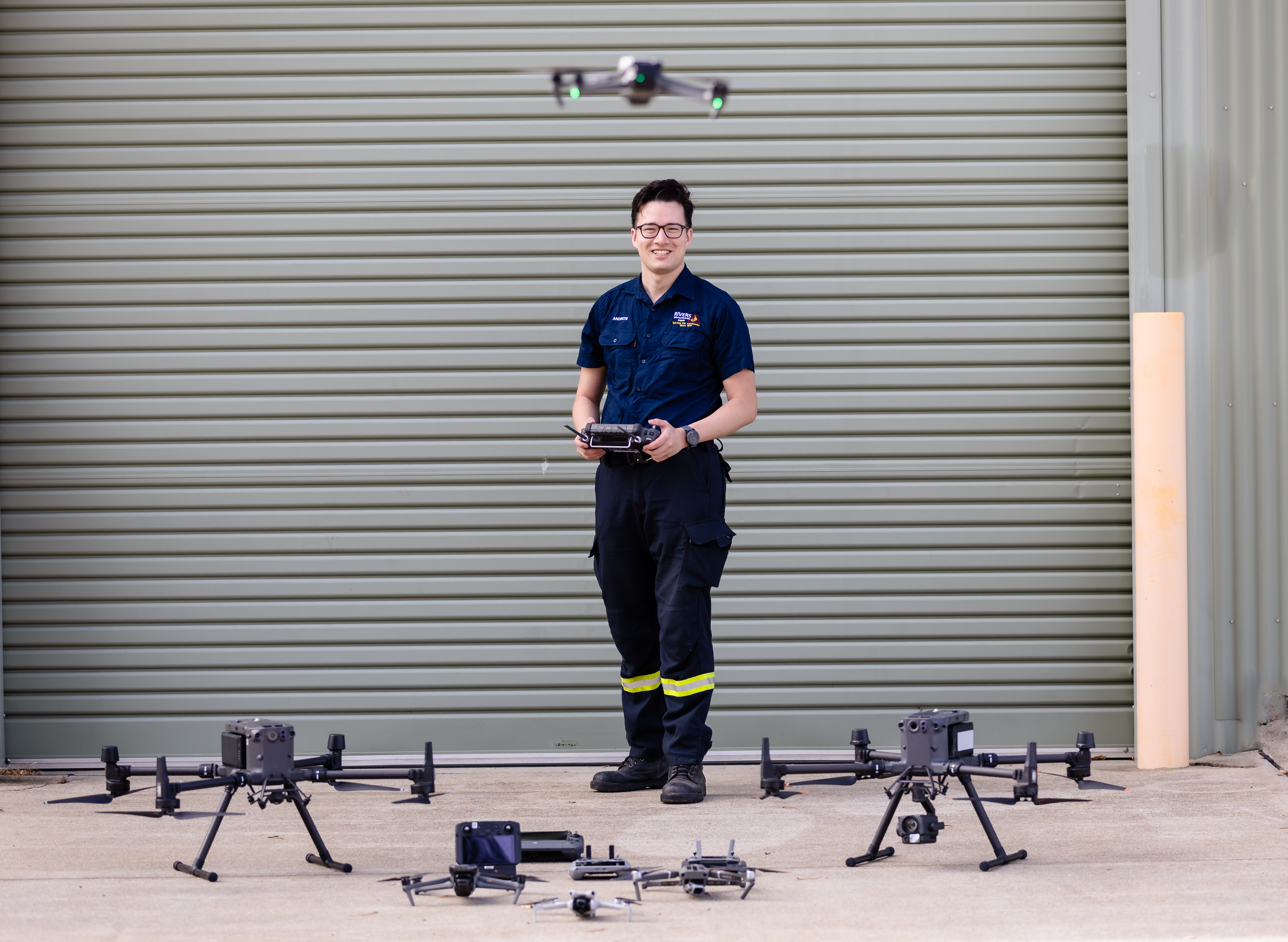 Drone operator with a controller and a range of training aircraft